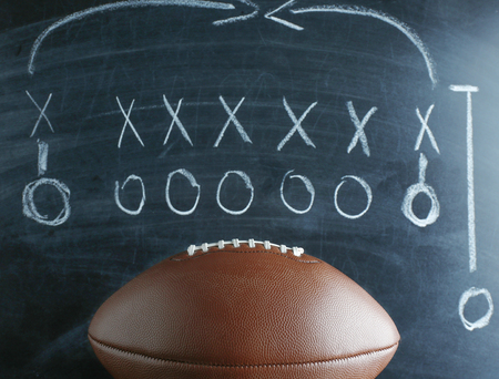 American football game strategy written with chalk on blackboardの写真素材