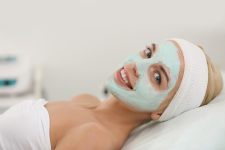 Young woman with facial mask at cosmetologistの写真素材