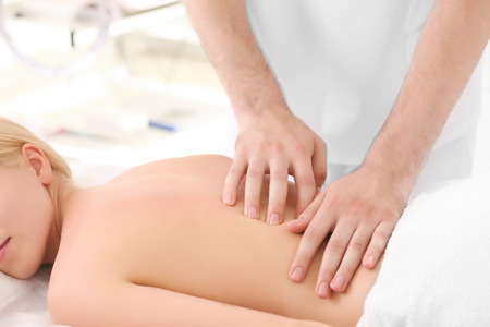 Young woman getting back massageの写真素材