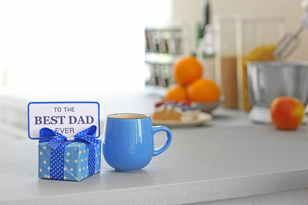 Happy Fathers Day concept. Tea cup with presents on tableの写真素材