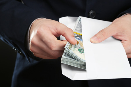 Businessman with money in envelope. Corruption conceptの写真素材