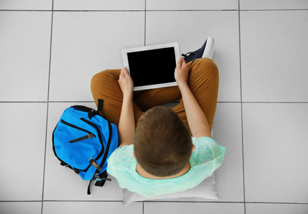 Cute schoolboy with tablet, top viewの写真素材