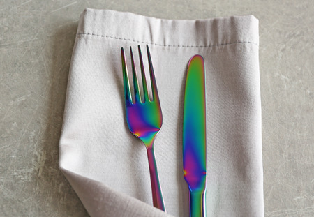 Table setting with fork, knife and napkin, closeup
