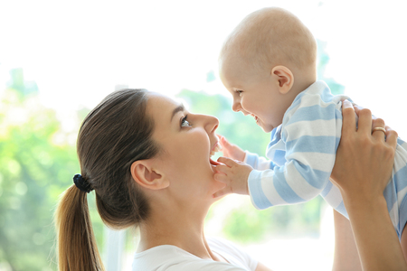 Mother and baby on light backgroundの写真素材