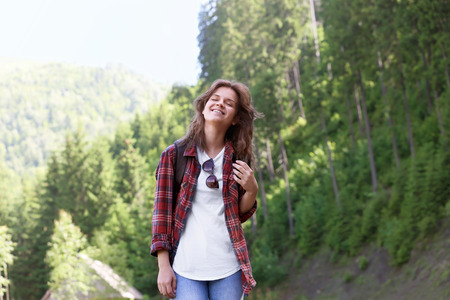 Young woman enjoying the beauty of mountain forestの写真素材
