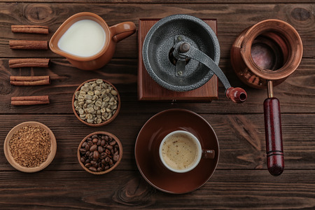 Fresh coffee with ingredients and accessories on wooden backgroundの写真素材