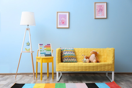 Yellow sofa with toys in children roomの写真素材