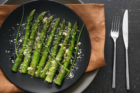 Grilled asparagus on black plateの写真素材