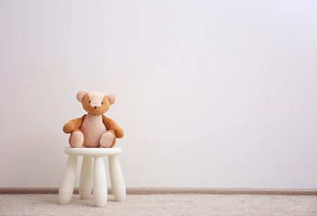 Children stool with toy on white wall backgroundの写真素材