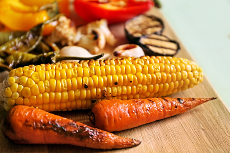 Grilled vegetables on wooden boardの写真素材