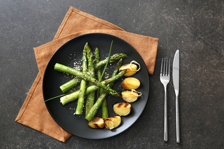 Grilled asparagus with potatoes on plateの写真素材
