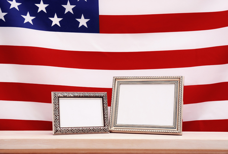 Two photo frames with USA flag on wooden tableの写真素材