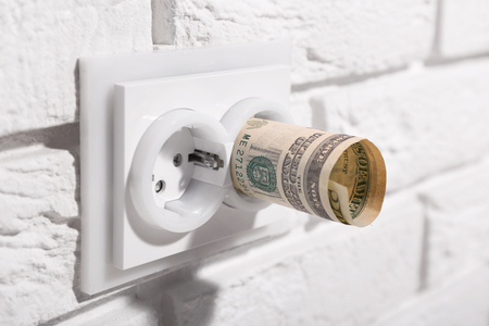 Dollars in socket on white wall
