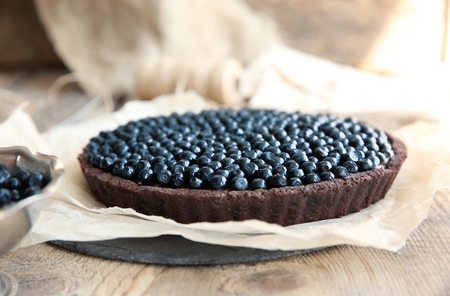 Delicious chocolate tart with berries on paper, closeupの写真素材