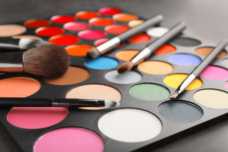 Colorful eye shadow palette with brushes, closeupの写真素材