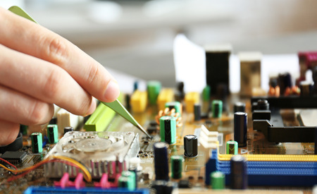 Man repairing motherboard, closeup