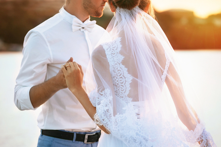 Groom and bride hugging, outdoorの写真素材
