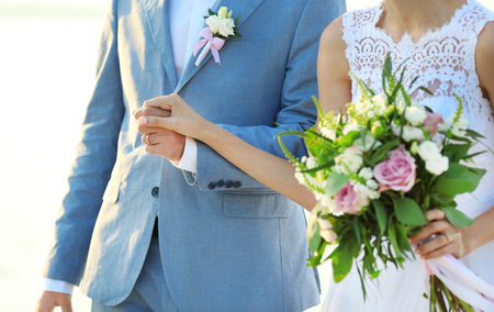 Happy wedding couple on river backgroundの写真素材