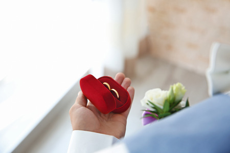 Groom with ring box, closeupの写真素材