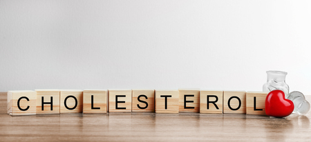 Wooden cubes with word Cholesterol on table