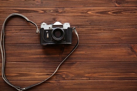 Retro camera on wooden background