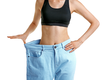 Girl in huge pants on white backgroundの写真素材