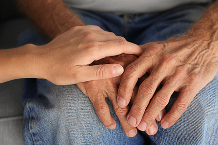 Old male and young female hands, closeupの写真素材