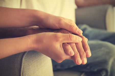 Old male and young female hands, closeupの写真素材