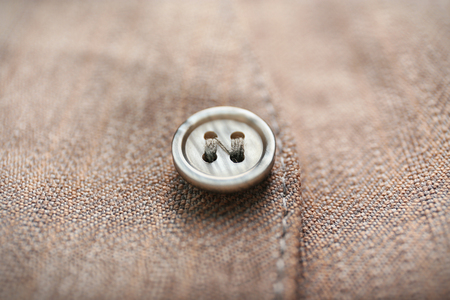 Grey button on clothes, close upの写真素材