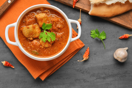 Tasty dinner chicken curry in soup plate on tableの写真素材