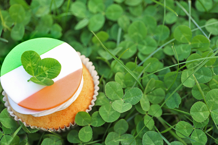 Tasty cupcake on clover leaves. Saint Patrics Day conceptの写真素材