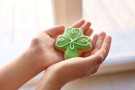 Woman holding decorative cookie. Saint Patrics Day conceptの写真素材