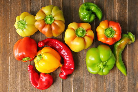 Fresh peppers on wooden tableの写真素材