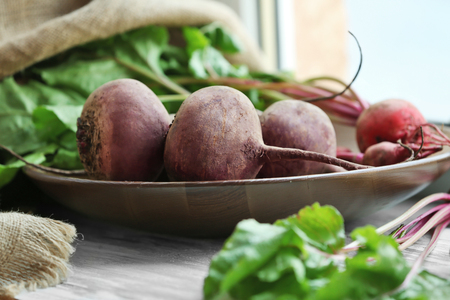 Ripe beets on a plate on windowsillの写真素材