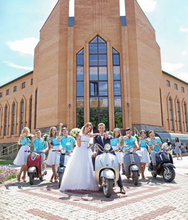 Newlyweds, bridesmaids and best men with scootersの写真素材
