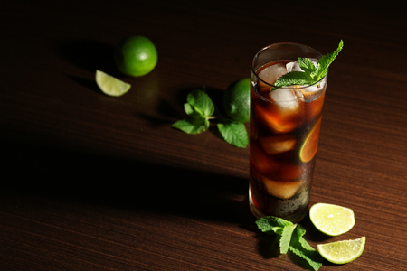 Cuba Libre cocktail with lime and mint on dark backgroundの写真素材