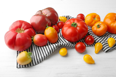 Composition of red and yellow tomatoes on white wooden backgroundの写真素材