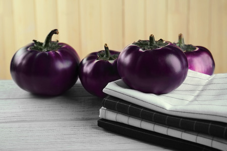 Fresh eggplants and clean napkins on tableの写真素材