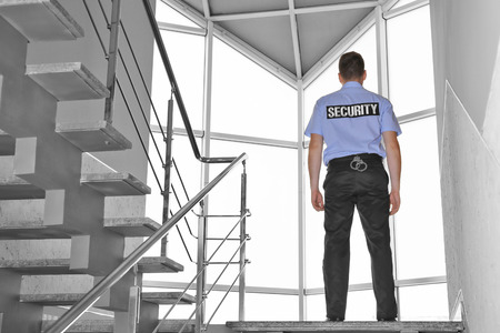 Security man standing on stairsの写真素材