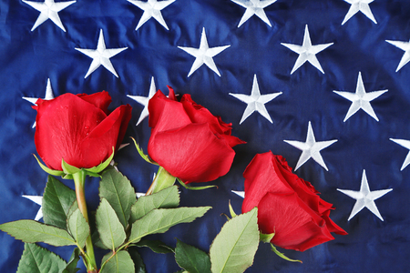 Red roses on American flag, closeupの写真素材
