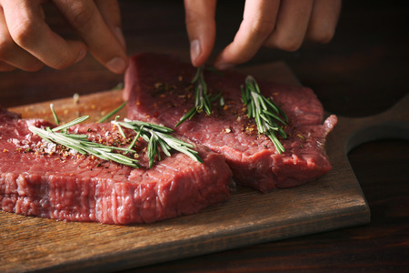 Butcher cooking pork meat on kitchen