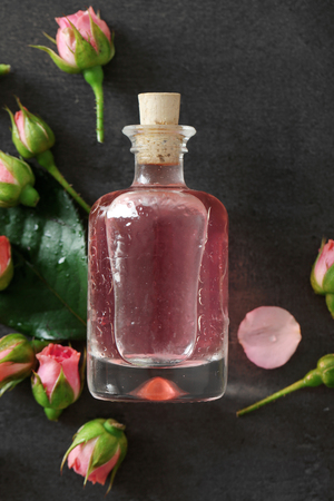 Bottle of aroma oil with roses, top viewの写真素材