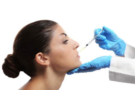 Procedure of facial injection isolated on whiteの写真素材