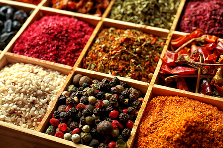Different spices in wooden cells, closeupの写真素材