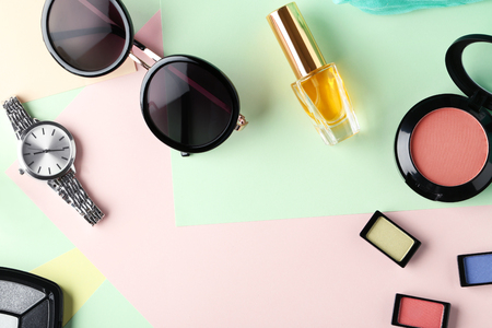 Set of decorative cosmetics and female accessories on color backgroundの写真素材