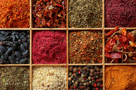 Different spices in wooden cells, closeupの写真素材