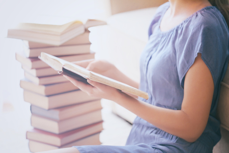 Woman reading old book at homeの写真素材