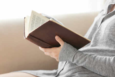 Woman reading old book at homeの写真素材