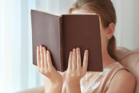Woman reading old book at homeの写真素材