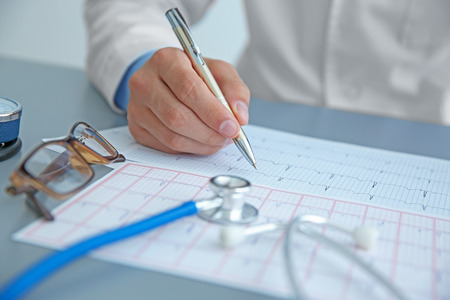 Male doctor at work in clinic officeの写真素材